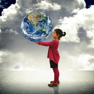 Child holding the world in her hands - Future and happiness concept