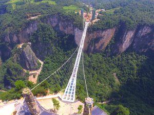 People visit a glass bridge at a gorge as it opens to public in Zhangjiajie, Hunan Province, China, August 20, 2016. Picture taken August 20, 2016. China Daily/via REUTERS ATTENTION EDITORS - THIS IMAGE WAS PROVIDED BY A THIRD PARTY. EDITORIAL USE ONLY. CHINA OUT.     TPX IMAGES OF THE DAY