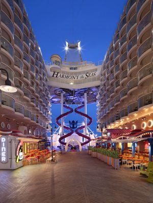 HM, Harmony of the Seas,The Boardwalk - Deck 6 Aft, no people, shops along walkway, balconies on sides, ship signage above, Ultimage Abyss slides in background,