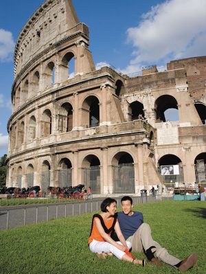 Europe, rome, Italy. Asian Couple on grass in front of colosseum. Shore excursion