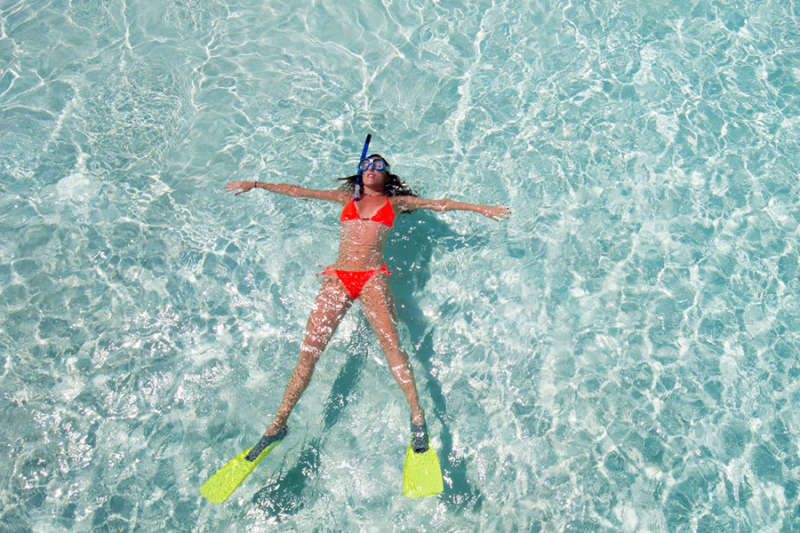 Woman floating with snorkeling gear