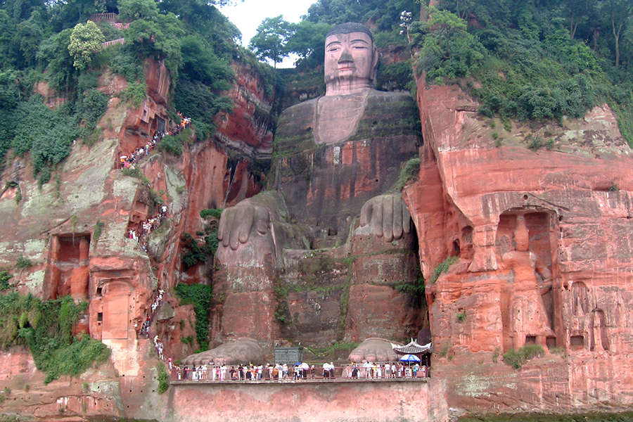 Es una escultura de más de 71 metros de altura que emula a este mítico personaje religioso. Actualmente es parte del Patrimonio de la Humanidad de la Unesco. A sus pies convergen los ríos Min Jiang, Dadu y Qingyi, y dada su fuerza era común que embarcaciones naufragaran en la región, por ello la iniciativa de crear a este eterno guardián que con mirada soñolienta, creas o no, alteró por alguna razón las corrientes, tranquilizando el flujo del agua. Investigadores sugieren que los restos de piedra que cayeron al agua pudieron ser la solución.