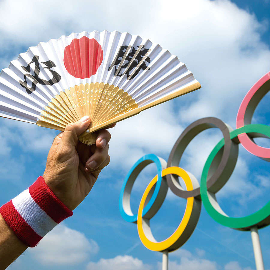 LONDON - APRIL 19, 2019: Hand holding a fan decorated with Japan
